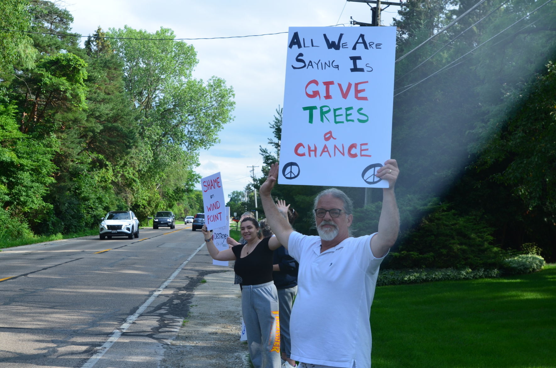 Protestors hold signs
